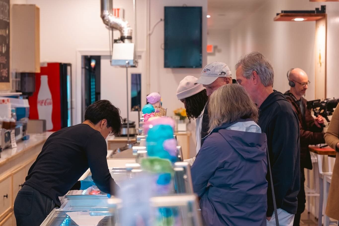 A team member serving guests at the case at The Bee Ice Cream