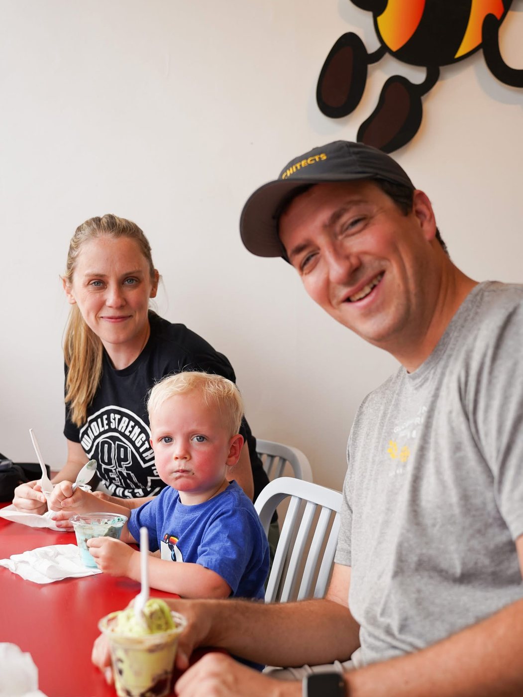 A family enjoying ice cream at a red table at The Bee